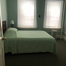 light blue green bed spread on bed at the Coolidge House at Hotel Coolidge